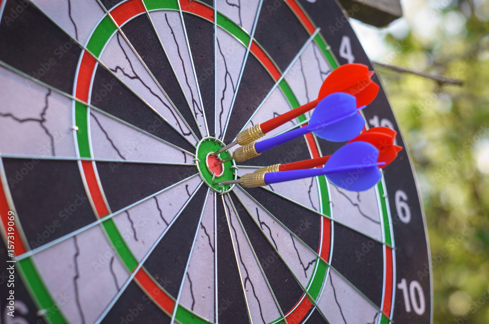 outdoor flying darts game with blurry green background outdoor flying darts game with blurry green background