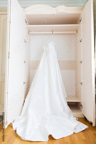 The perfect wedding dress with a full skirt on a hanger © protivnica