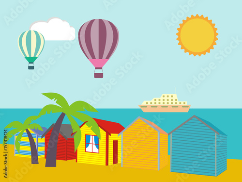 A row of beach huts against blue sky and sand and sea.