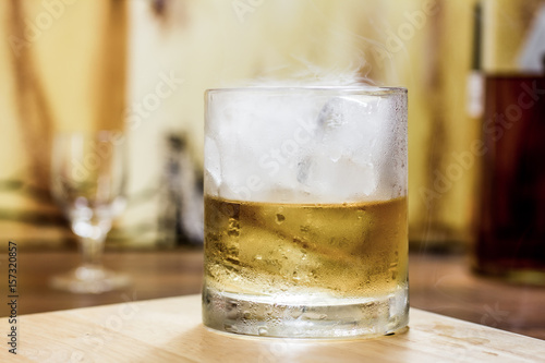 Whiskey tumbler glass smoky ice