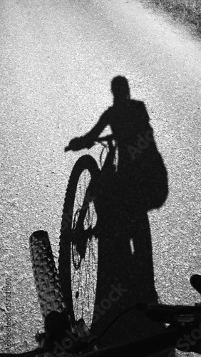Shadow of a woman cyclist and a bicycle on the road. Slovakia