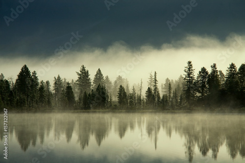 Fog over the forest by the shore of the lake. Yakutia, lake Darpir.