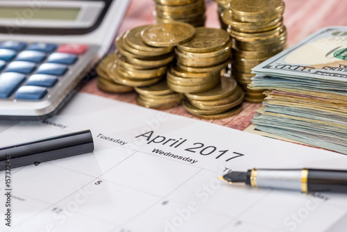 calendar, money, calculator and pen. tax concept. april.