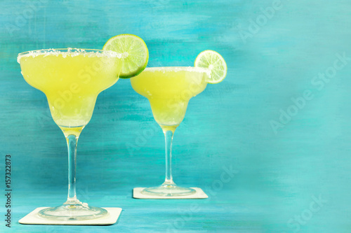 Lemon Margarita cocktails on vibrant turquoise with copyspace