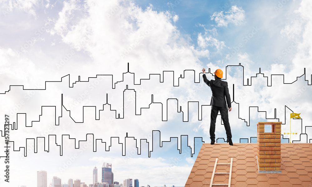 Man architect draw silhouette of modern city on blue sky. Mixed media Man architect draw silhouette of modern city on blue sky. Mixed media