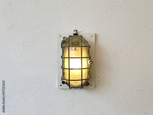 Retro, vintage and  industrial style of wall lamp on white painted concrete wall