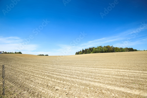 Cultivated fields under the blue sky of Bavaria, Germany.