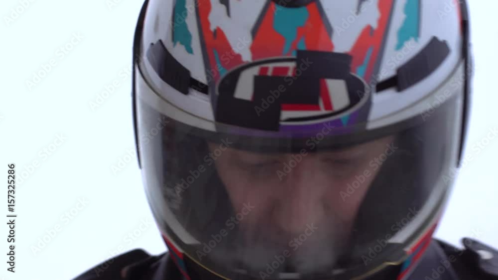 motorcycle driver puts on his helmet. Close-up motorcycle driver puts on his helmet. Close-up