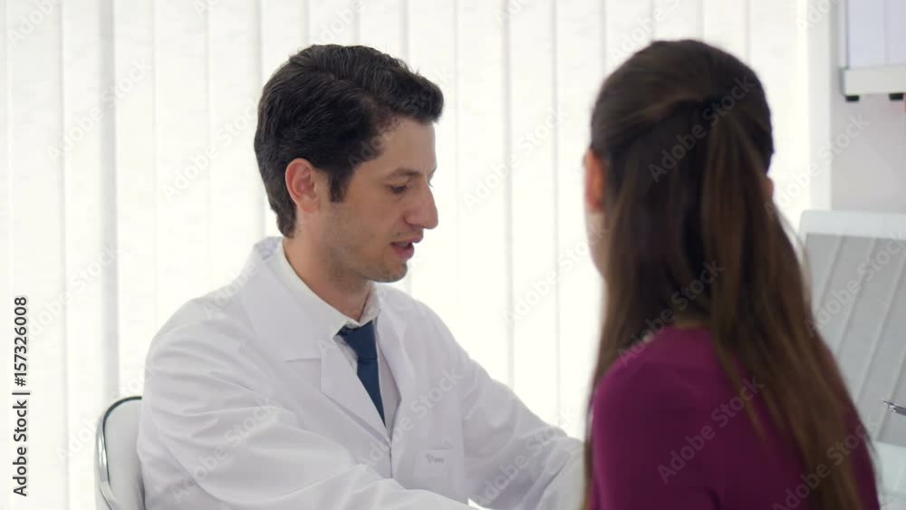 Woman getting medical consultation from a doctor in a hospital. Woman getting medical consultation from a doctor in a hospital.