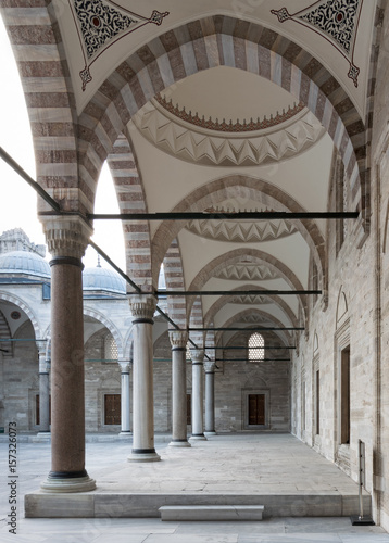 Passage leading to Sulaymaniye mosque, a public Ottoman Baroque style mosque, with columns, arches and marble floor, Fatih district, Istanbul, Turkey photo