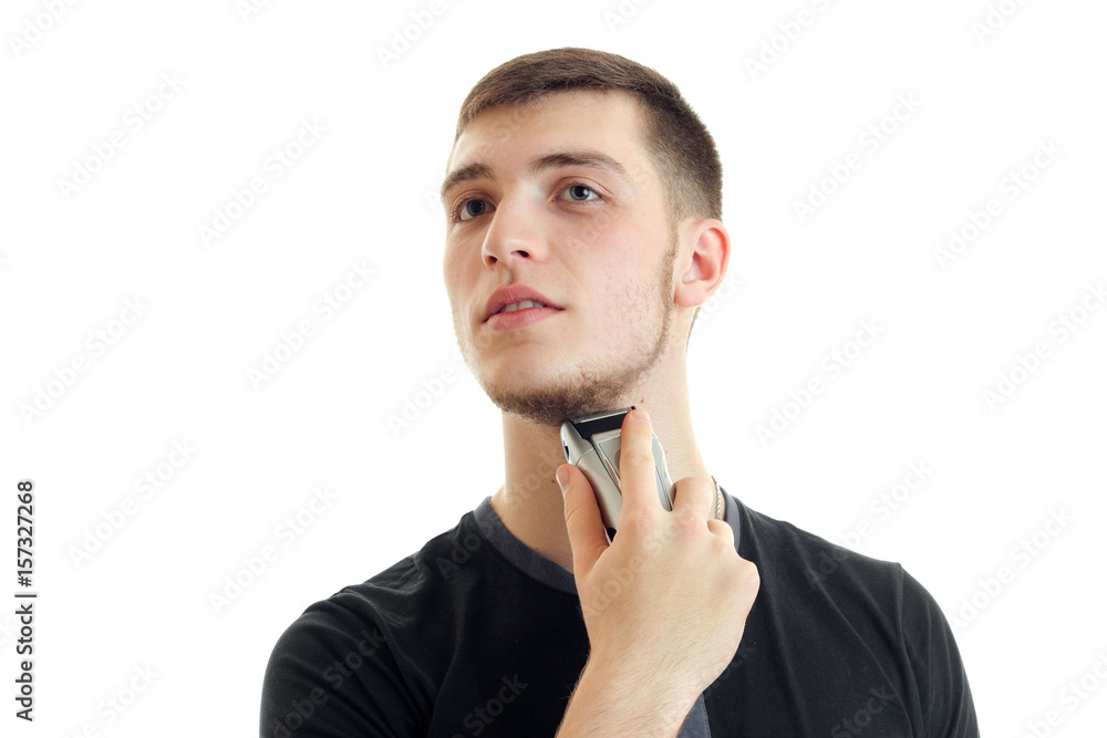 young man shaving his bears with a trimmer young man shaving his bears with a trimmer