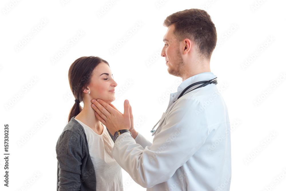 young doctor gently moves fragile throat cute girl isolated on a white background young doctor gently moves fragile throat cute girl isolated on a white background