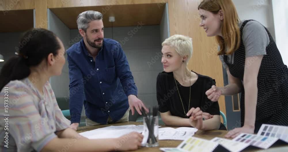 Group of coworkers discussing a project Group of coworkers discussing a project