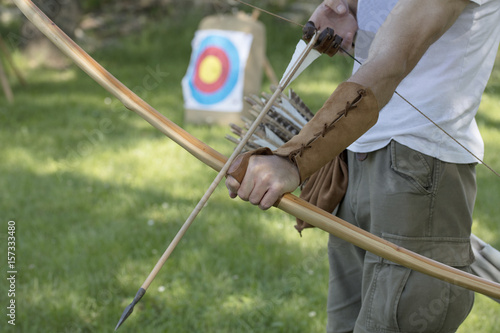 Archer with medieval English longbow and arrows. Sport and recreation concept.
