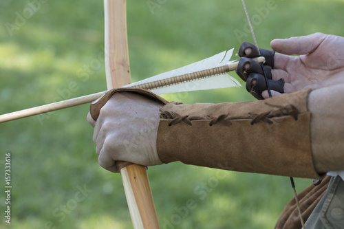 Archer with medieval English longbow and arrows. Sport and recreation concept.