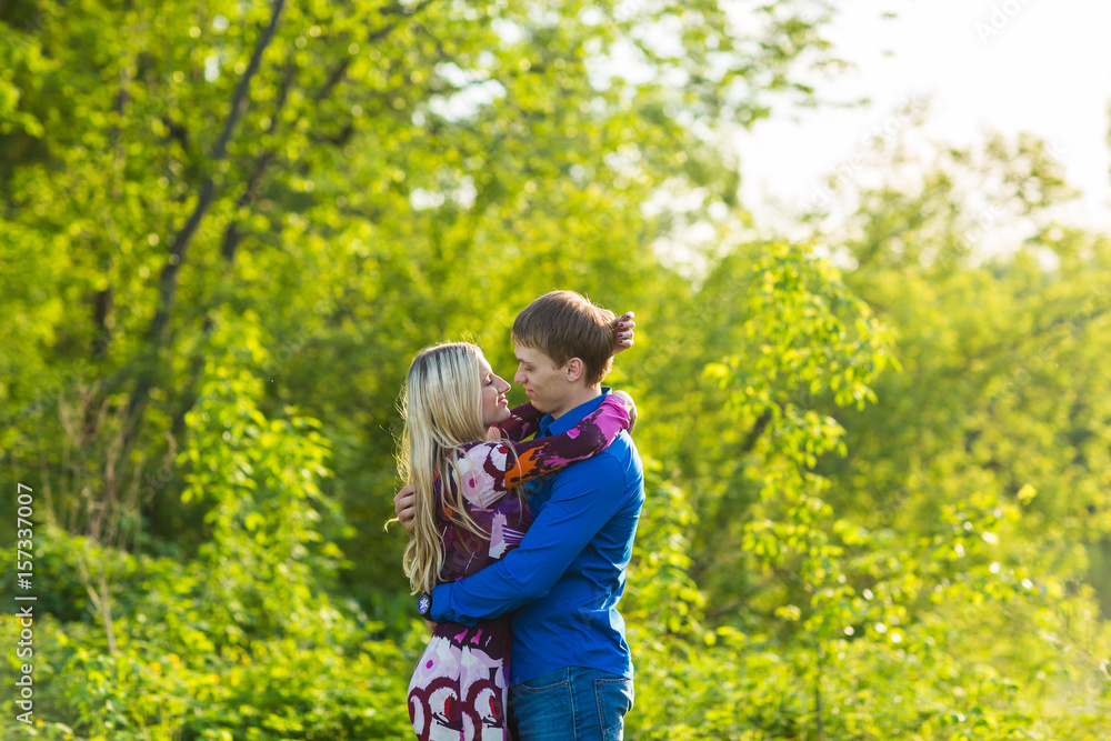 Romantic happy couple in love on nature. Man and woman kissing in summer park. Romantic happy couple in love on nature. Man and woman kissing in summer park.