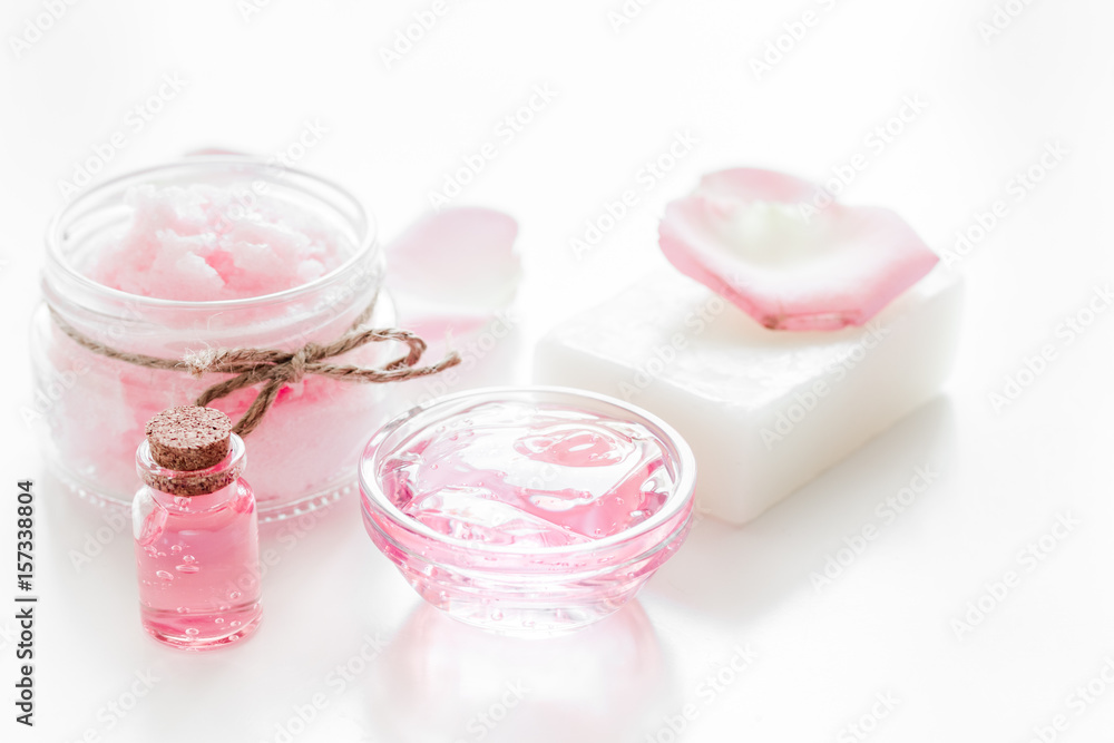 homemade spa with rose cosmetic set, cream, soap and oil on white background homemade spa with rose cosmetic set, cream, soap and oil on white background