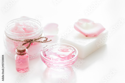 homemade spa with rose cosmetic set, cream, soap and oil on white background