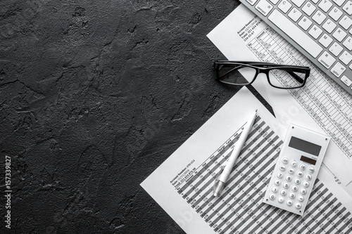 taxes accounting in office work space on dark desk background top view mockup photo