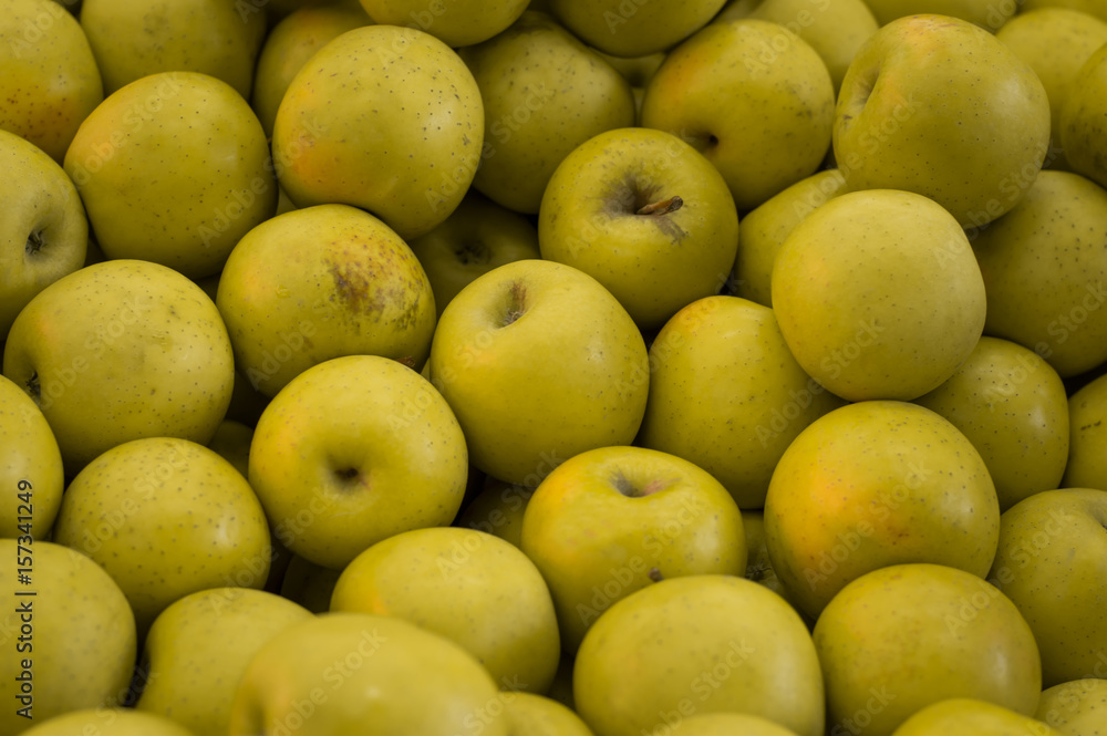 Green and red apples on shelf