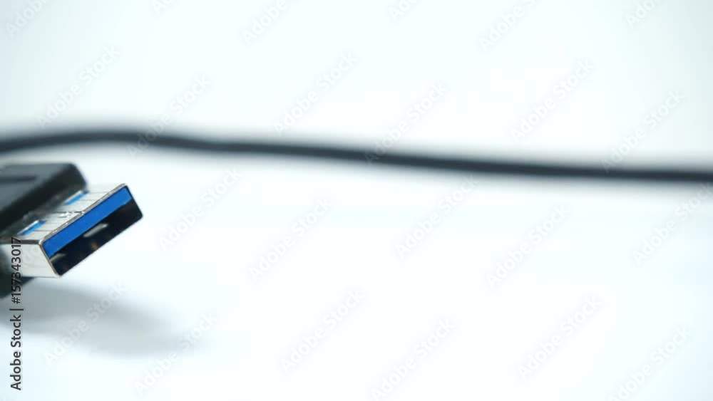 Black USB cable plug on white, dolly shot 4K ProRes HQ codec Black USB cable plug on white, dolly shot 4K ProRes HQ codec