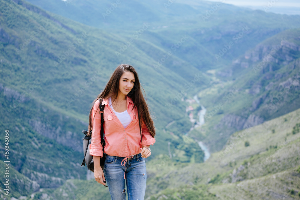 joyful woman travel mountains with backpack