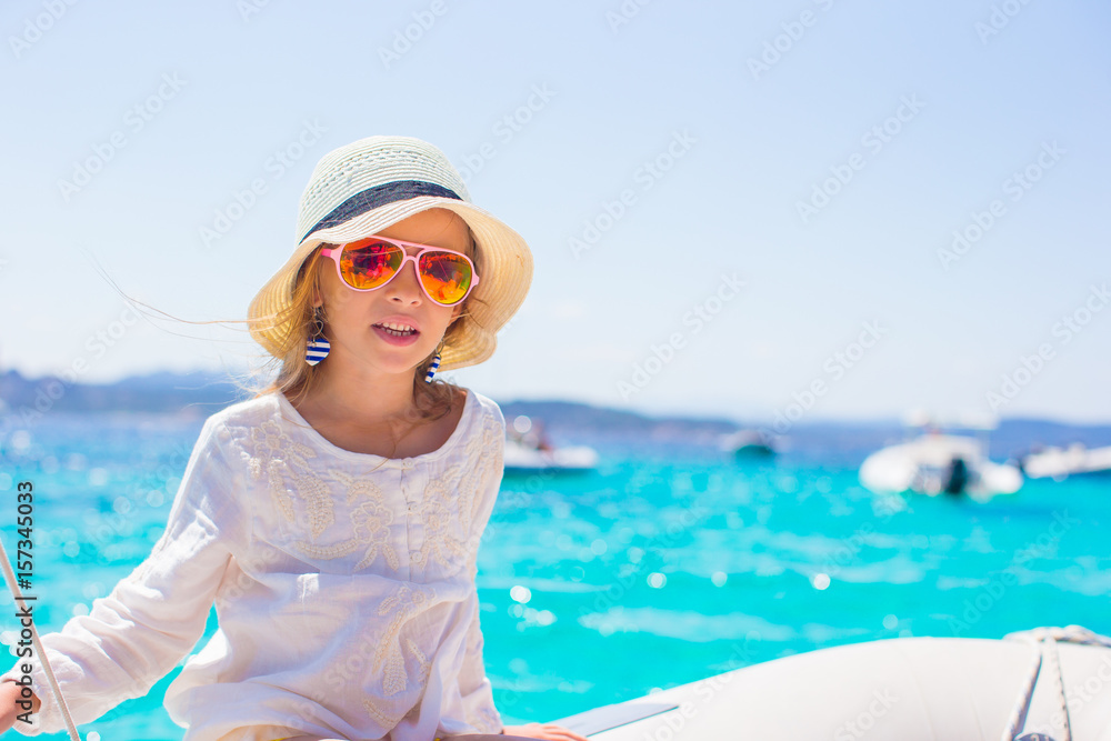 Little girl enjoying sailing on boat in the open sea Little girl enjoying sailing on boat in the open sea