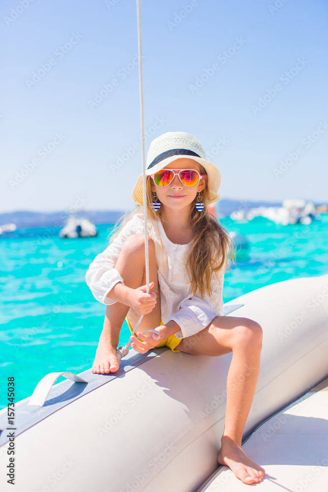 Little girl enjoying sailing on boat in the open sea Stock Photo