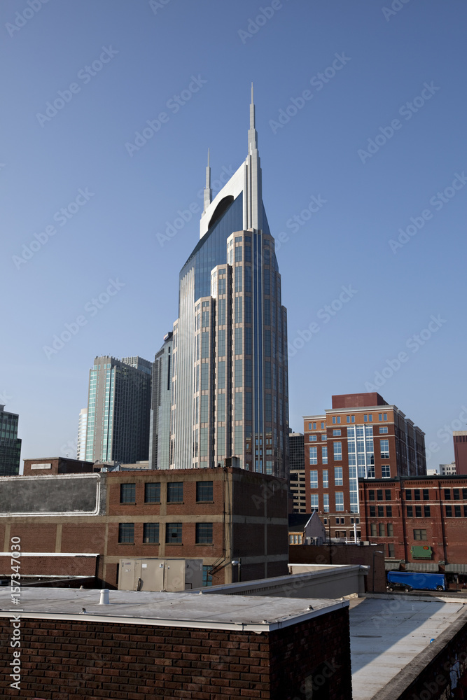 Obraz premium beautiful towering new office building surrounded by older brick buildings in Nashville, Tennessee