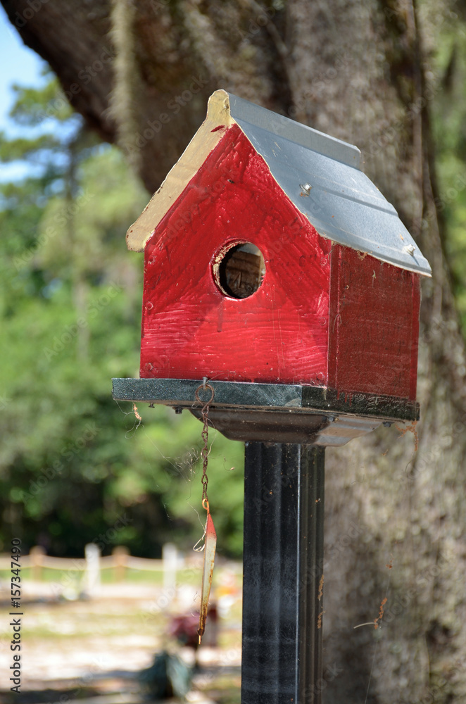 A wooden birdhouse painted red A wooden birdhouse painted red