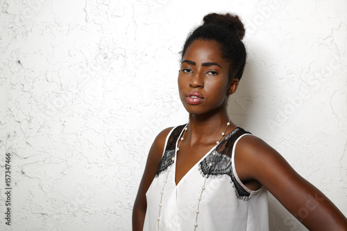Fotografi Beautiful young African American female model on a white background