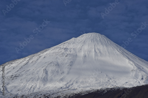 Snow capped peak of Antuco Volcano (2,979 metres) in Laguna de Laja National Park in the Bio Bio region of Chile.