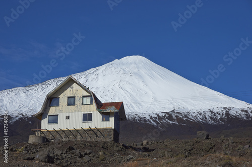 Snow capped peak of Antuco Volcano (2,979 metres) rising above the small ski resort in Laguna de Laja National Park in the Bio Bio region of Chile. photo