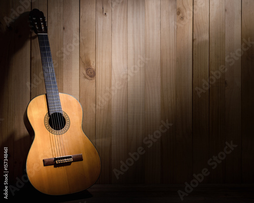 Acoustic guitar on wood background with copy space.