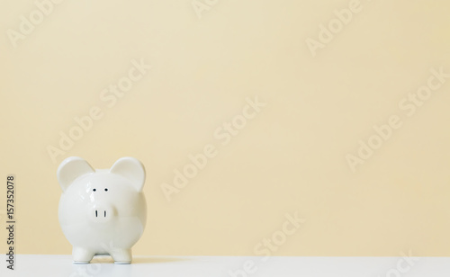 White piggy bank on a yellow background
