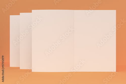 Three blank white open brochure mock-up on orange background