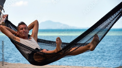 Man lies on a hammock photo