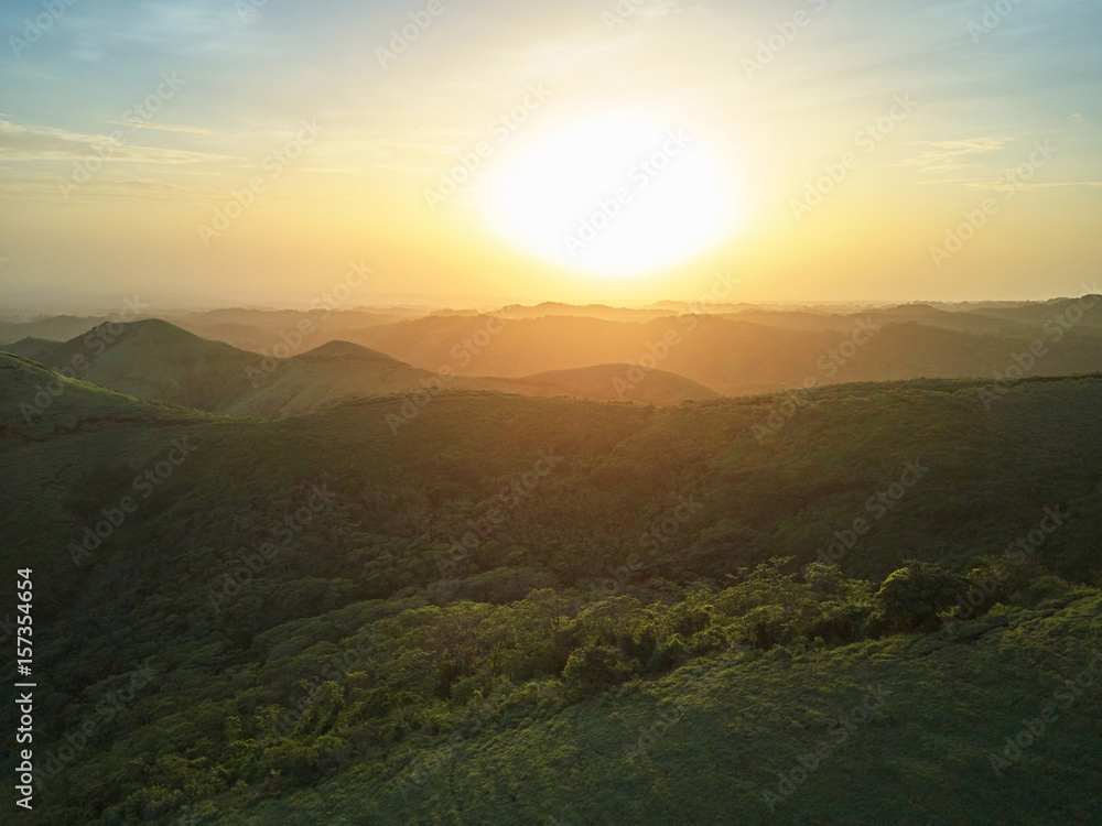 Sunset over green hills landscape