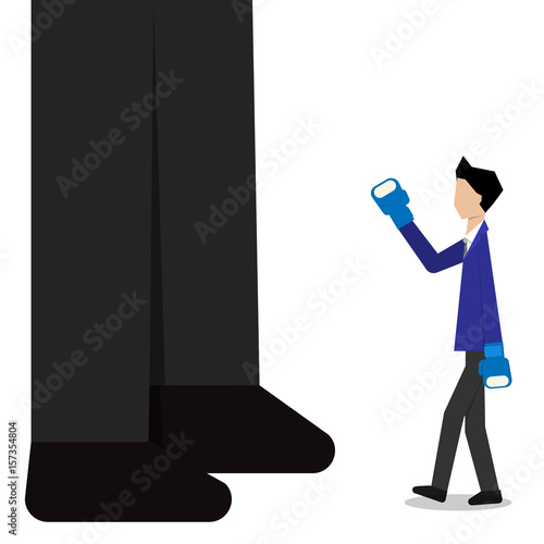Businessman boxing against a giant