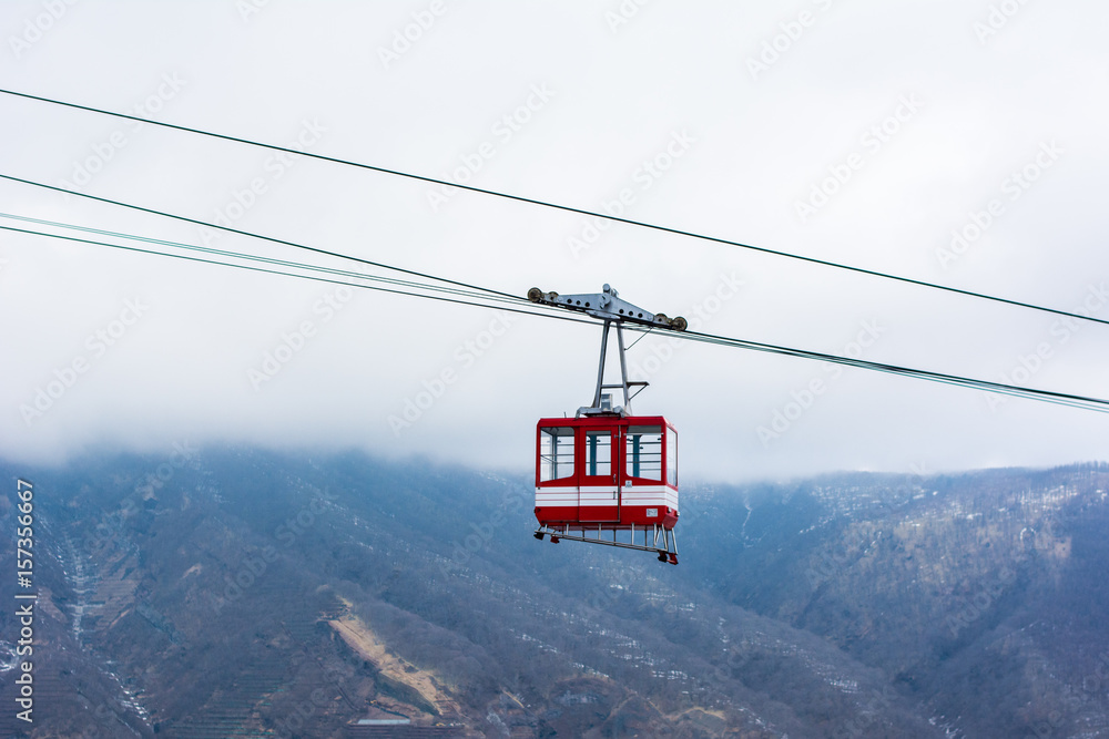 Fototapeta premium Nikko ropeway cable car. Red cable car with tourists is traveling up to the top of the mountain, Nikko, Japan.