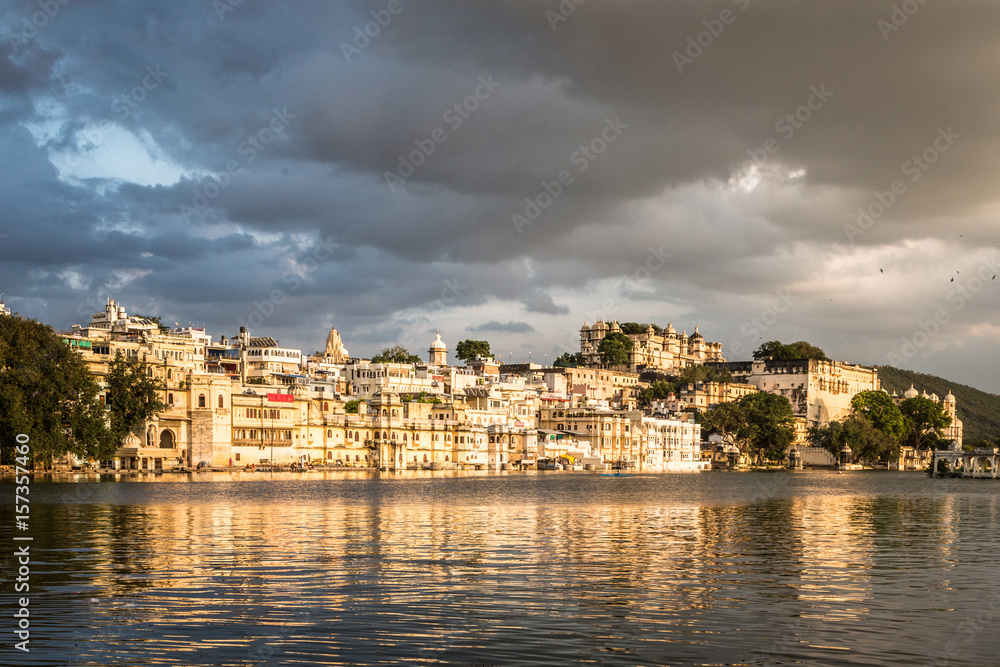 Sunset over lake Pichola with Udaipur old town lakefront and the City Palace in Rajasthan, India