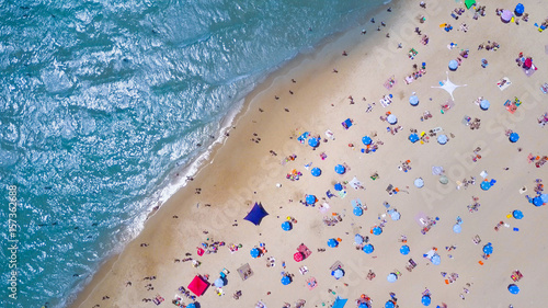 Tropical beach with colorful umbrellas - Top down aerial view