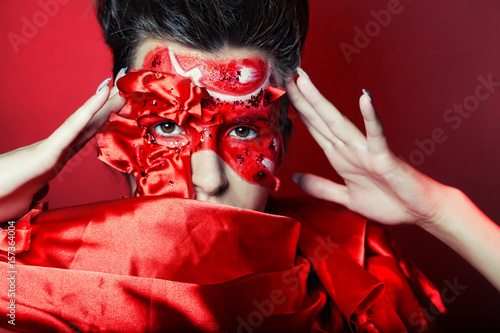 woman with creative red face art photo