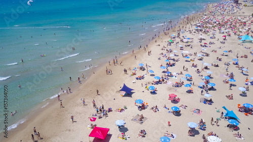 Tropical beach with colorful umbrellas - Aerial view