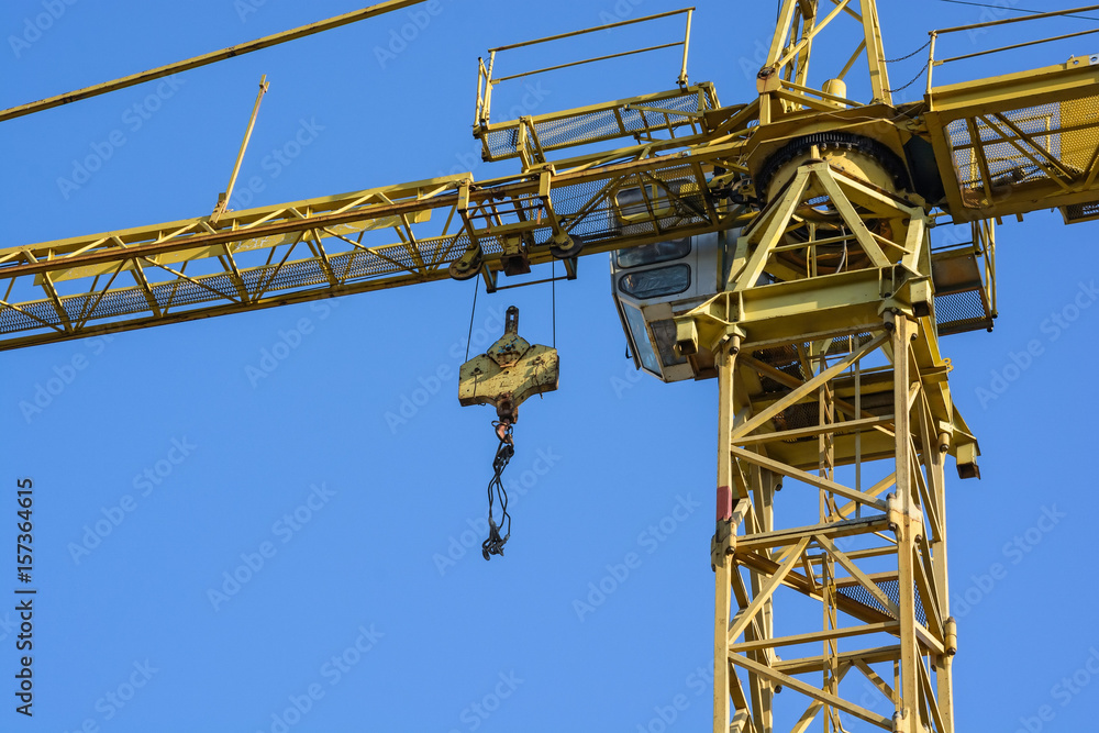 Close up construction crane builds new building Close up construction crane builds new building