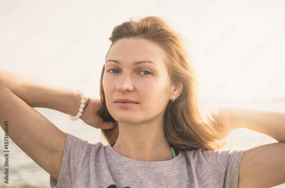 Portrait of an attractive blonde woman with blue eyes in sunlight flare Portrait of an attractive blonde woman with blue eyes in sunlight flare
