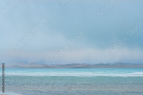 Fototapeta Naklejka Na Ścianę i Meble -  panoramic view of lake at cloudy day with great mountains on background 