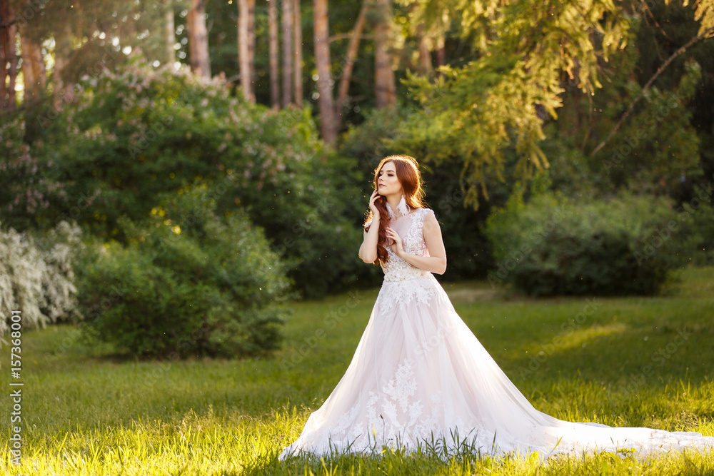 Beautiful redhead Bride. Portrait outdoor in sunset light. Pretty young caucasian redhead girl