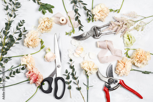 Fototapeta Naklejka Na Ścianę i Meble -  The florist desktop with working tools on white wooden background