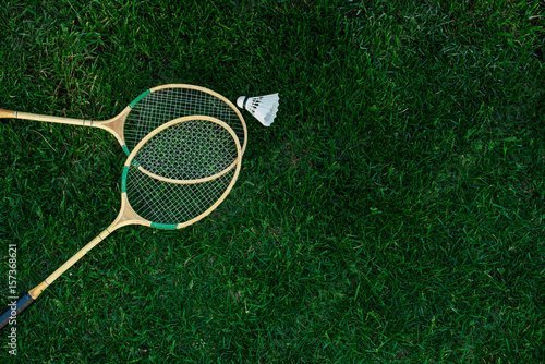 Badminton rackets and shuttlecocks isolated on green, top view, Fresh lawn 